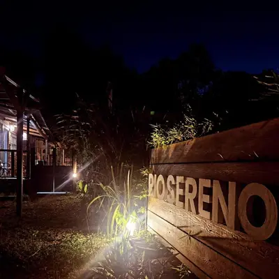 a sign that says presario on a wooden fence at night at Rio Sereno in Santa Rosa de Calamuchita