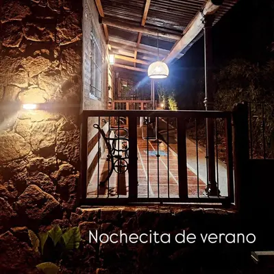 a balcony of a house at night with a light at Rio Sereno in Santa Rosa de Calamuchita