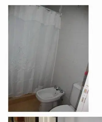 a bathroom with a toilet and a shower curtain at Dulces Sueños in Villa Carlos Paz