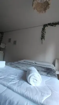 a white towel laying on a bed in a bedroom at Refugio urbano frente a Sanatorio Allende in Cordoba