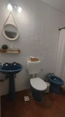 a bathroom with a blue toilet and a sink at Refugio urbano frente a Sanatorio Allende in Cordoba
