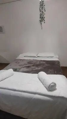 a bedroom with a bed with two white towels on it at Refugio urbano frente a Sanatorio Allende in Cordoba