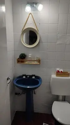 a bathroom with a blue sink and a mirror at Refugio urbano frente a Sanatorio Allende in Cordoba
