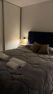 a large bed with two pillows on it in a room at Dpto con vista a las sierras in Cordoba