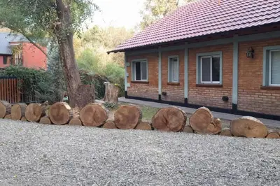 a pile of logs sitting in front of a house at Chalet del arroyo in La Porteña