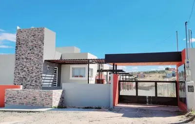 a building with a gas station with a sky background at Departamento ideal Pileta, Parrilla y Pet friendly in Cavalango