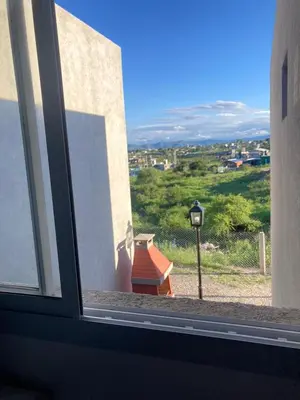 a window with a view of a building and a street light at Departamento ideal Pileta, Parrilla y Pet friendly in Cavalango