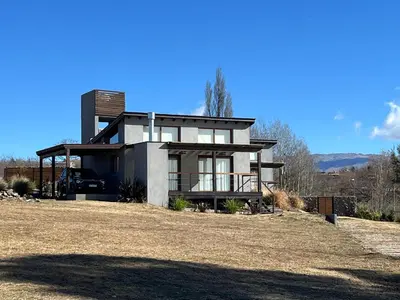 a house sitting on top of a dirt field at Las Champas in Villa Yacanto