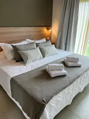 a large white bed with two pillows on it at Las Champas in Villa Yacanto