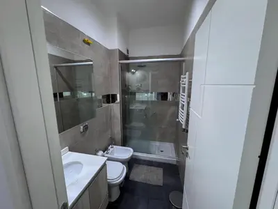 a bathroom with a toilet and a sink and a shower at Girolami Temporarios Villa Carlos Paz in Villa Carlos Paz