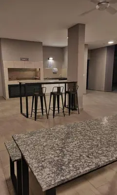 a kitchen with a table and chairs in a room at Girolami Temporarios Villa Carlos Paz in Villa Carlos Paz