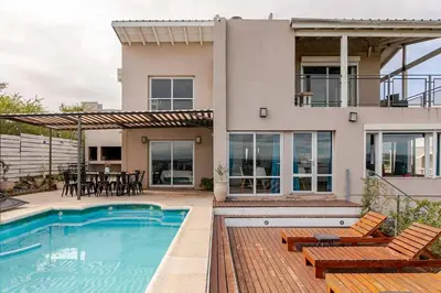 a home with a swimming pool and a house at Casa Dos Lunas in Bialet Massé