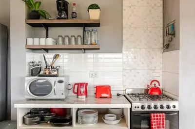 a small kitchen with a stove and a microwave at Casa Dos Lunas in Bialet Massé