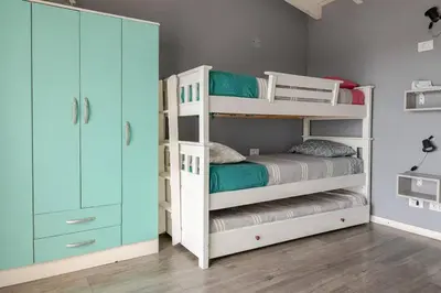 a bedroom with two bunk beds and a closet at Casa Dos Lunas in Bialet Massé