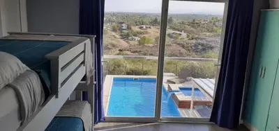 a bedroom with a view of a swimming pool at Casa Dos Lunas in Bialet Massé