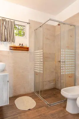 a bathroom with a shower with a toilet and a sink at Casa Dos Lunas in Bialet Massé