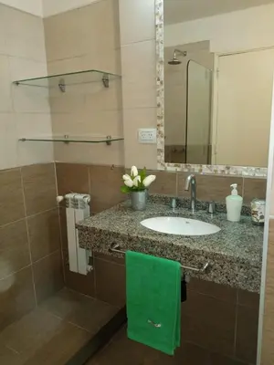 a bathroom with a sink and a green towel at NGdeptosVCP in Villa Carlos Paz