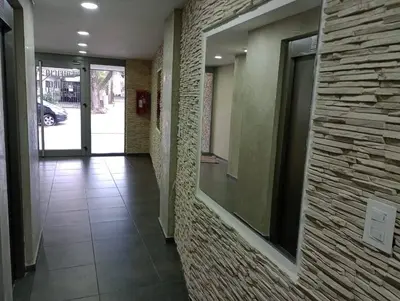 a hallway of a building with a brick wall at NGdeptosVCP in Villa Carlos Paz
