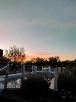 a sunset over a parking lot with a boat at Hosteria Manantial de Carpintería in Carpintería