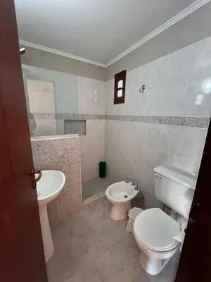 a bathroom with a toilet and a bidet and a sink at Hosteria Manantial de Carpintería in Carpintería