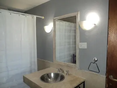 a bathroom with a sink and a mirror at Casitas de Campo in Mina Clavero