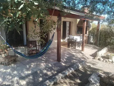 a patio with a hammock in front of a house at Casitas de Campo in Mina Clavero