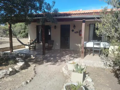 a small house with a table in front of it at Casitas de Campo in Mina Clavero