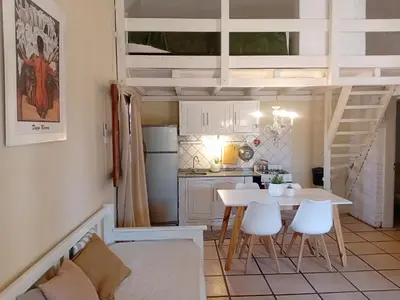 a kitchen with a table and chairs in a room at Casitas de Campo in Mina Clavero