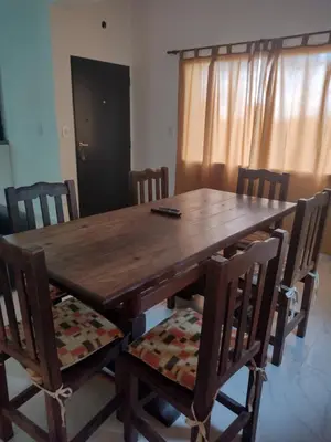 a dining room table with chairs and a wooden table at Mi lugar en el mundo in Cortaderas