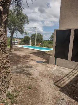 an empty swimming pool in front of a building at Mi lugar en el mundo in Cortaderas