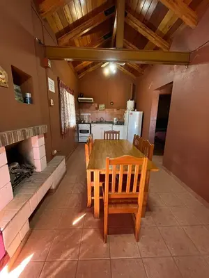 a kitchen and dining room with a table and chairs at Cabaña Villa Carlos Paz in Villa Carlos Paz