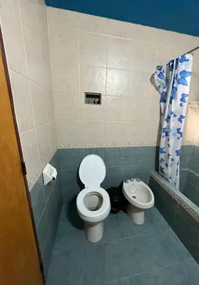 a bathroom with a toilet and a sink at Cabaña Villa Carlos Paz in Villa Carlos Paz