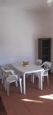 a white table and chairs in a room at Miralrio in Santa Rosa de Calamuchita