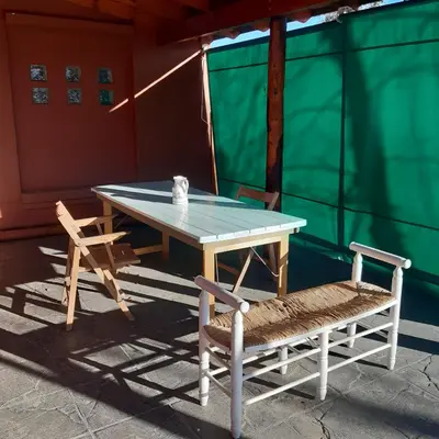 a ping pong table and two chairs on a patio at Miralrio in Santa Rosa de Calamuchita