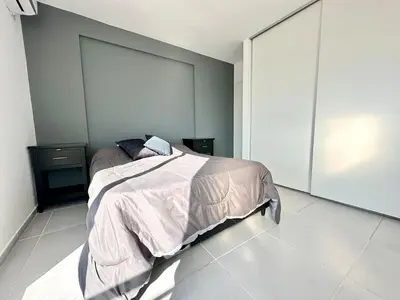 a bedroom with a bed in a white room at Alojamiento para 3 personas in Cordoba