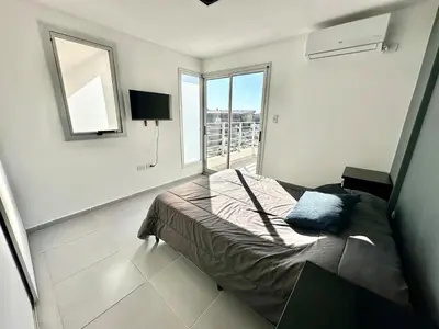 a bedroom with a bed and a large window at Alojamiento para 3 personas in Cordoba