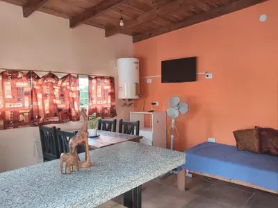 a dining room with a table with a cat statue on it at Departamento Los Jacaranda in Villa Carlos Paz