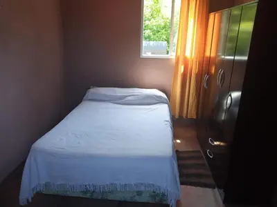 a small bed in a small room with a window at Departamento Los Jacaranda in Villa Carlos Paz