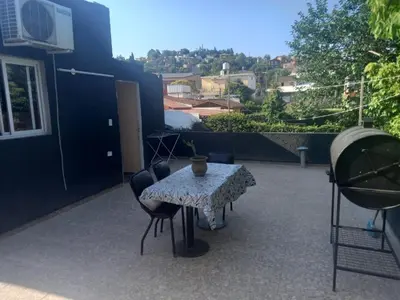 a table and chairs sitting on a patio at Departamento Los Jacaranda in Villa Carlos Paz