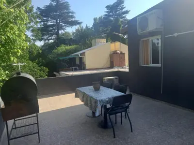 a patio with a table and chairs and a fireplace at Departamento Los Jacaranda in Villa Carlos Paz