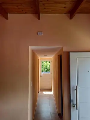 an empty hallway with a door and a window at Departamento Los Jacaranda in Villa Carlos Paz