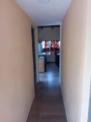 a hallway leading to a kitchen and a dining room at Departamento Los Jacaranda in Villa Carlos Paz