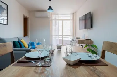 a dining room table with plates and glasses on it at Moderno y Confortable Depto Zona Universidad - Sanatorio Allende in Cordoba