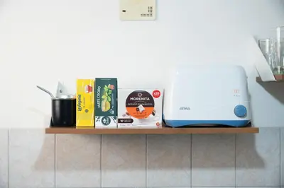 a shelf with books and a printer on it at Moderno y Confortable Depto Zona Universidad - Sanatorio Allende in Cordoba