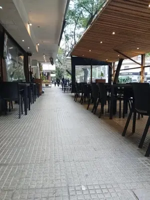 an empty patio with tables and chairs in a restaurant at Moderno y Confortable Depto Zona Universidad - Sanatorio Allende in Cordoba