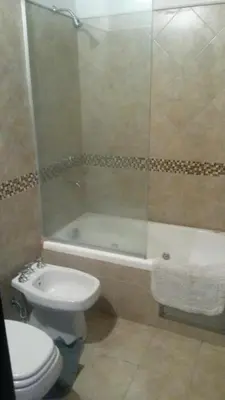 a bathroom with a toilet and a shower and a sink at Depto a 10 min de Villa General Belgrano in Villa Ciudad Parque