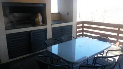a blue table and chairs on a balcony at Depto a 10 min de Villa General Belgrano in Villa Ciudad Parque