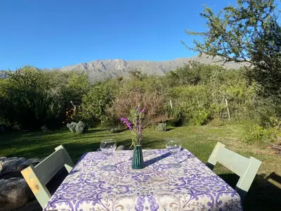 a table with a vase of flowers sitting on it at Glamping Traslasierra Carpa Norte in San Javier