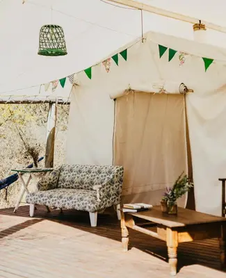 a tent with a chair and a table at Glamping Traslasierra Carpa Norte in San Javier