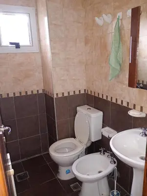 a bathroom with a toilet and a sink at Sueños in Villa Carlos Paz